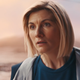 The thirteenth Doctor looks at a bunch of other Doctors in stunned silence.